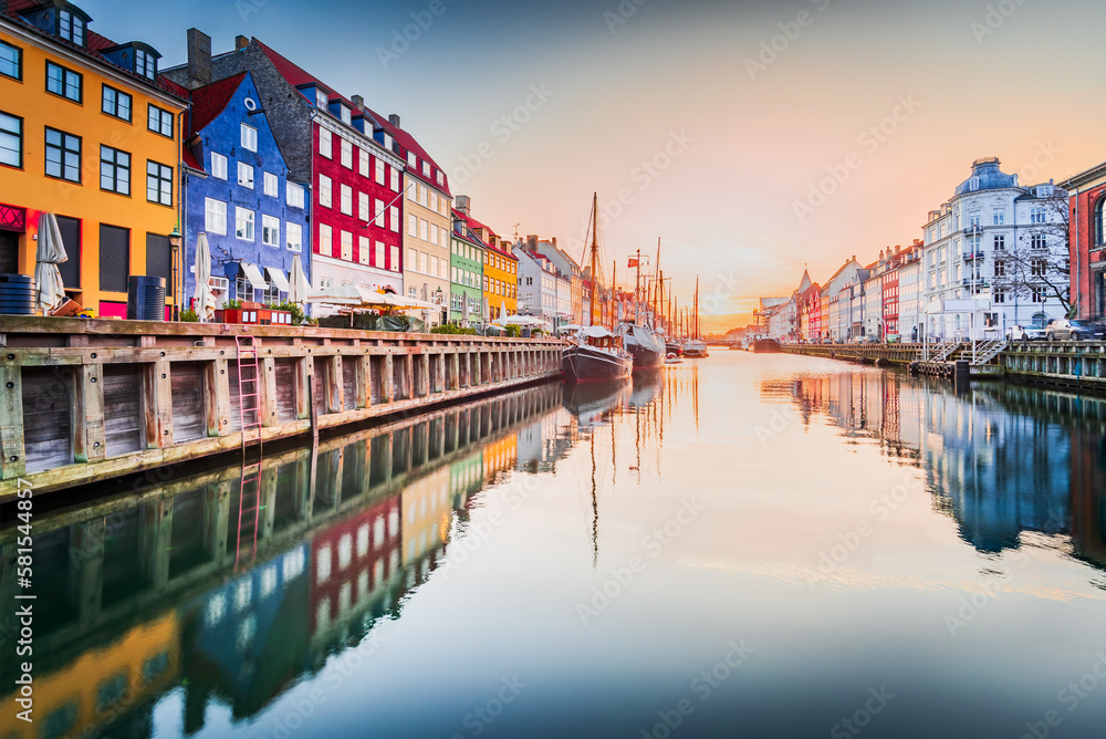 Copenhagen, Denmark. Nyhavn, Kobenhavn's iconic canal, colorful sunrise water reflection.