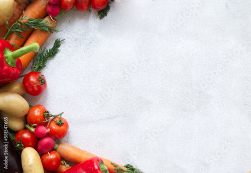 Fresh vegetables arranged on a light textured background copy space