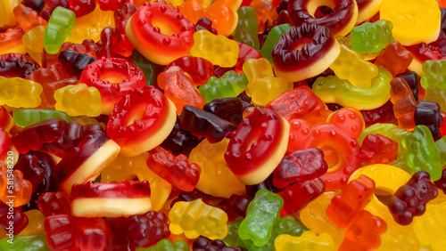 Assorted colorful gummy candies. Top view. Jelly donuts. Jelly bears. Isolated on a white background.