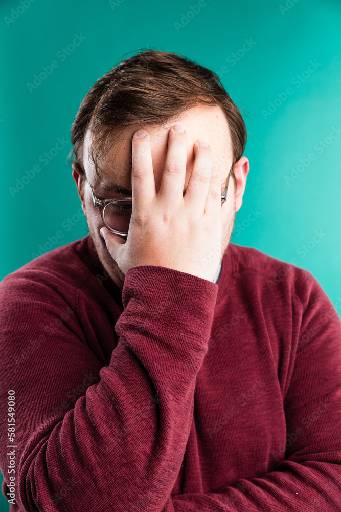 stressed man with hand over his face