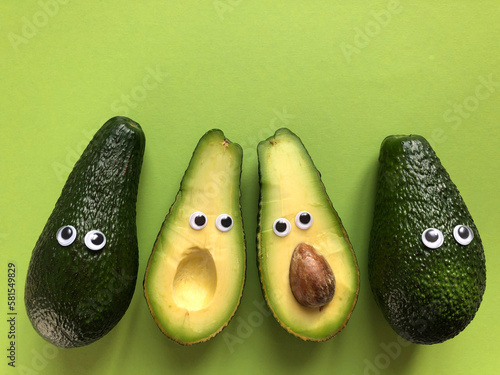 Avocados with googly eyes, whole and cut in half