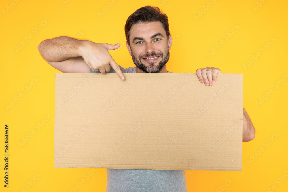 Handsome man holding empty board and pointing finger on board. Guy showing blank board with copyspace. Idea and offer. Your advertisement. Blank advertising board with empty space for text, mockup. Handsome man holding empty board and pointing finger on board. Guy showing blank board with copyspace. Idea and offer. Your advertisement. Blank advertising board with empty space for text, mockup.