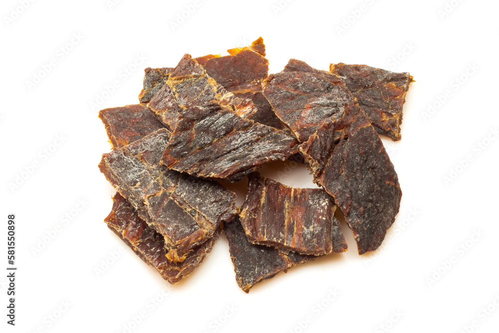Stack of dry meat slices isolated on white background. Beef jerky pieces