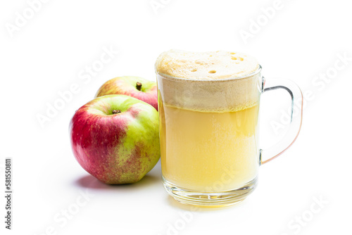 Homemade fresh squeezed apple juice in a clear glass isolated on white photo