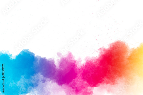 Multi colour powder explosion on white background. Launched colourful dust particles splashing.