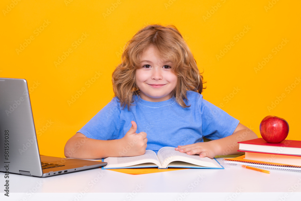 Child from elementary school with book isolated on yellow background. Little student, clever nerd pupil ready to study. First time to school. Concept of education and learning. Child from elementary school with book isolated on yellow background. Little student, clever nerd pupil ready to study. First time to school. Concept of education and learning.