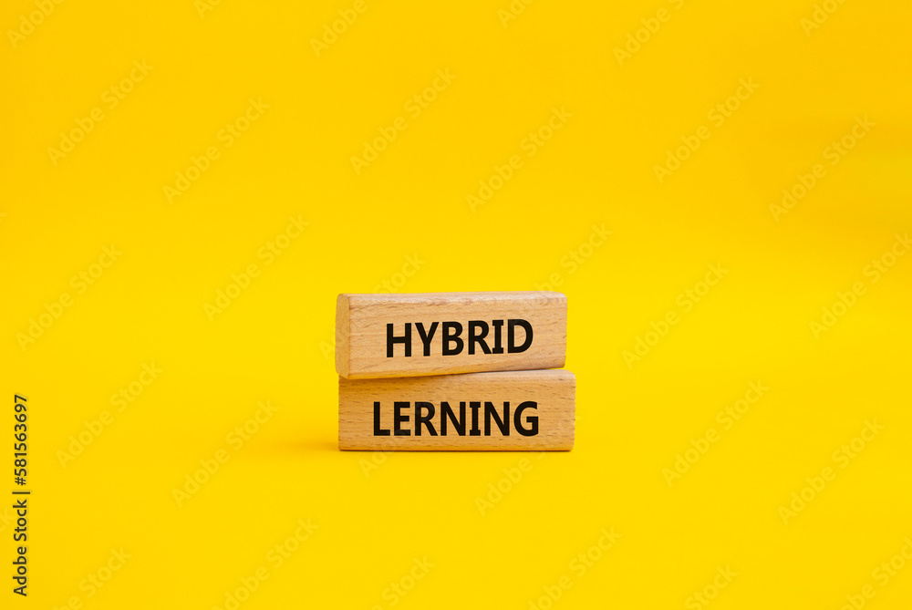 Hybrid learning symbol. Concept word Hybrid learning on wooden blocks. Beautiful yellow background. Business and Hybrid learning concept. Copy space Hybrid learning symbol. Concept word Hybrid learning on wooden blocks. Beautiful yellow background. Business and Hybrid learning concept. Copy space