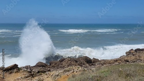 Set of big waves hits steep coast in Portugal.