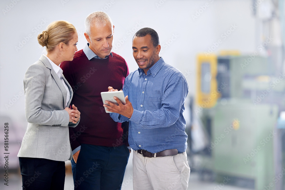 Giving feedback about operations. the management of a factory using a tablet during a warehouse inspection. Giving feedback about operations. the management of a factory using a tablet during a warehouse inspection.