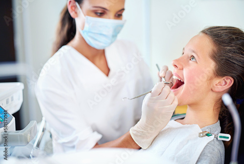 Just a quick clean. a young girl have a checkup at the dentist.