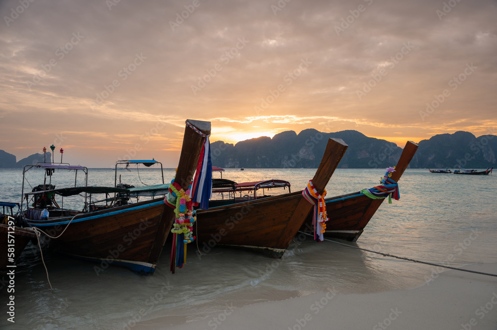 Traditional Thai longtail boats at sunset. Long Beach, Phi Phi island, Krabi Province, Andaman Sea.