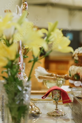 Holy communion in golden cup on table on church.Taking holy Communion.Cup of glass with red wine.