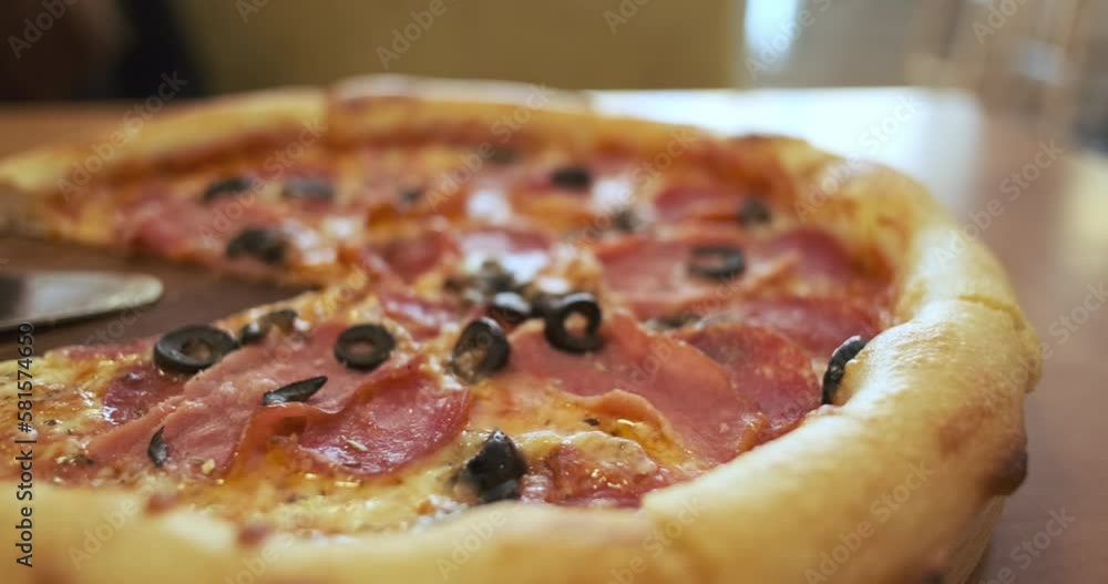 Meat pizza, close-up, side view. Panorama of fresh Italian pizza with pepperoni, bacon and olives. Meat pizza, close-up, side view. Panorama of fresh Italian pizza with pepperoni, bacon and olives.