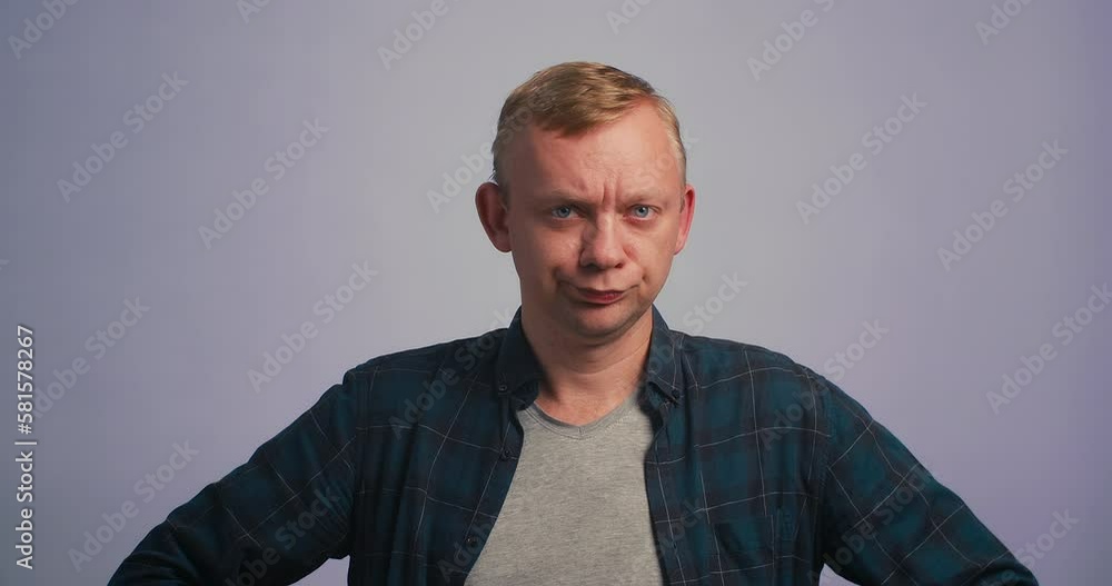 Portrait of disappointed young man throws up his hands, with hope looking camera. Studio shot Portrait of disappointed young man throws up his hands, with hope looking camera. Studio shot