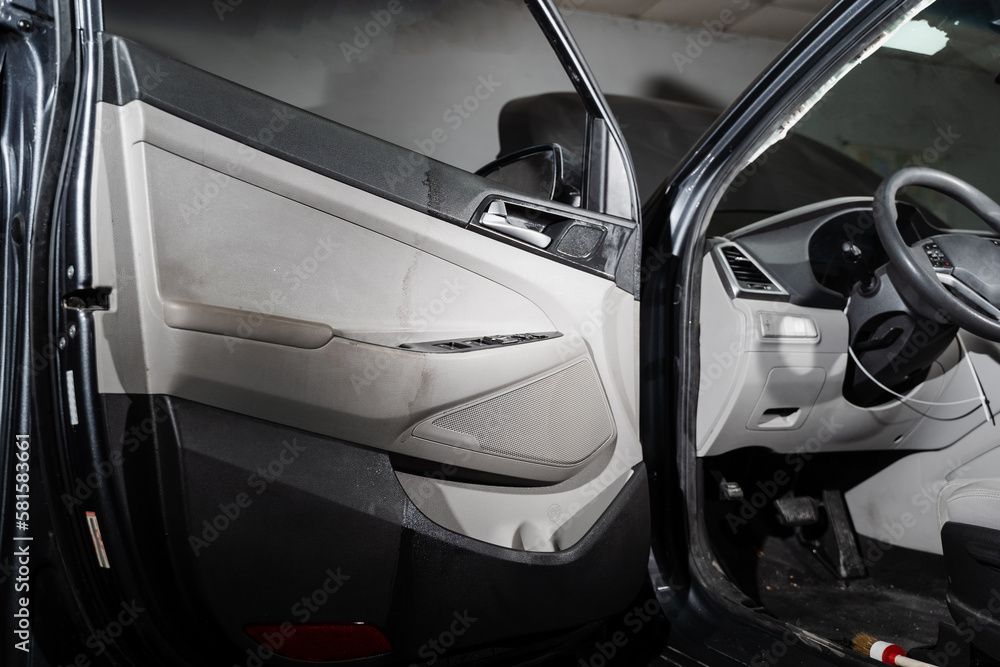 Before and after auto detailing cleaning of car door card. Half of car
