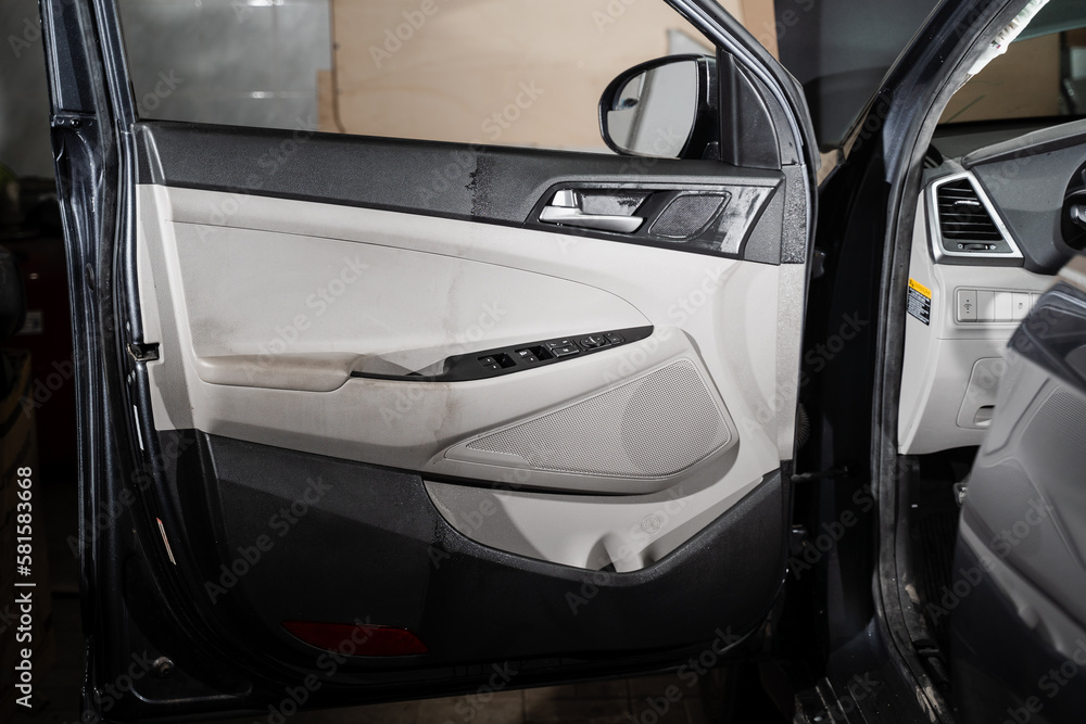 Before and after auto detailing cleaning of car door card. Half of car