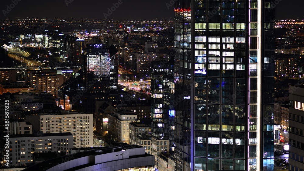 View of at night glass buildings and modern business skyscrapers,. View of modern skyscrapers and business buildings in downtown. Big city at night. View of at night glass buildings and modern business skyscrapers,. View of modern skyscrapers and business buildings in downtown. Big city at night.