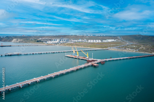 Cargo port in the Black Sea-Azov basin. Panoramic view of the shore and sea area with berths. Fragment. Shooting from a drone.