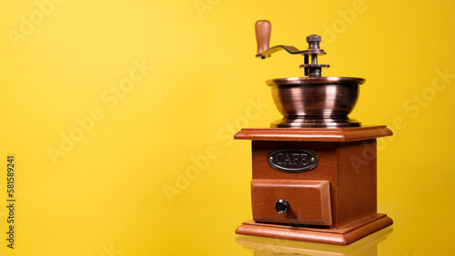 Traditional wooden coffee mill grinder over white background