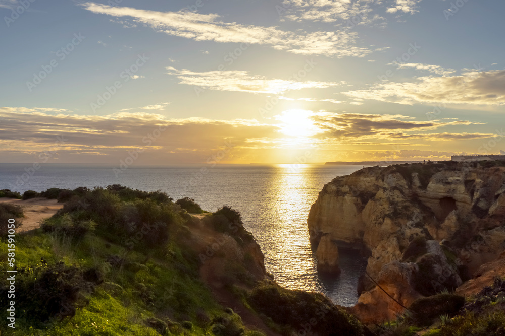 Sunset at Algarve coast outside Lagos, Portugal. Portuguese beaches and shores of the city of Lagos.
