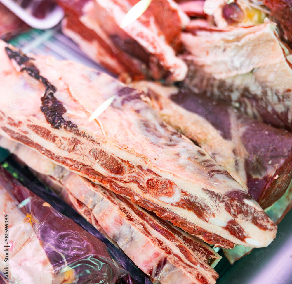 Pieces of beef meat laid out for sale in refrigerated display