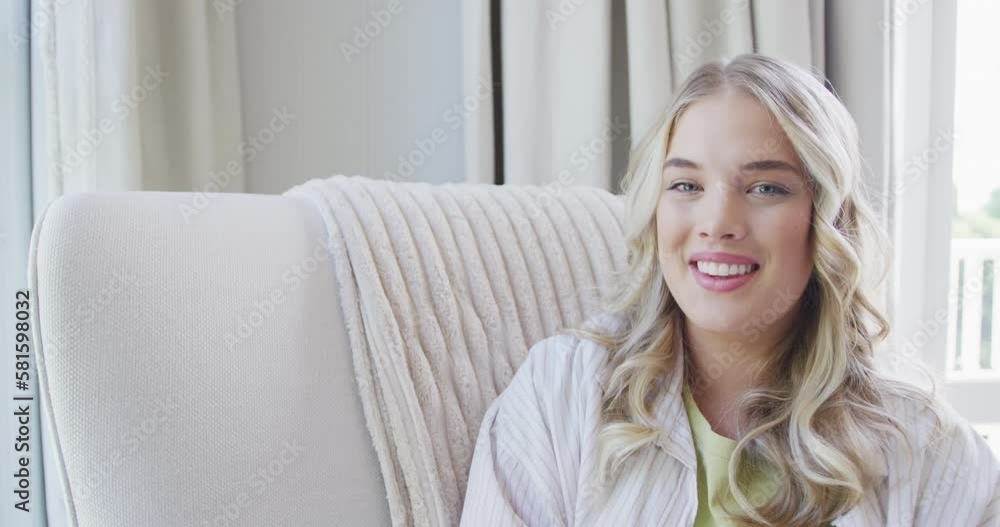 Portrait of happy caucasian plus size woman sitting on armchair at home in slow motion Portrait of happy caucasian plus size woman sitting on armchair at home in slow motion