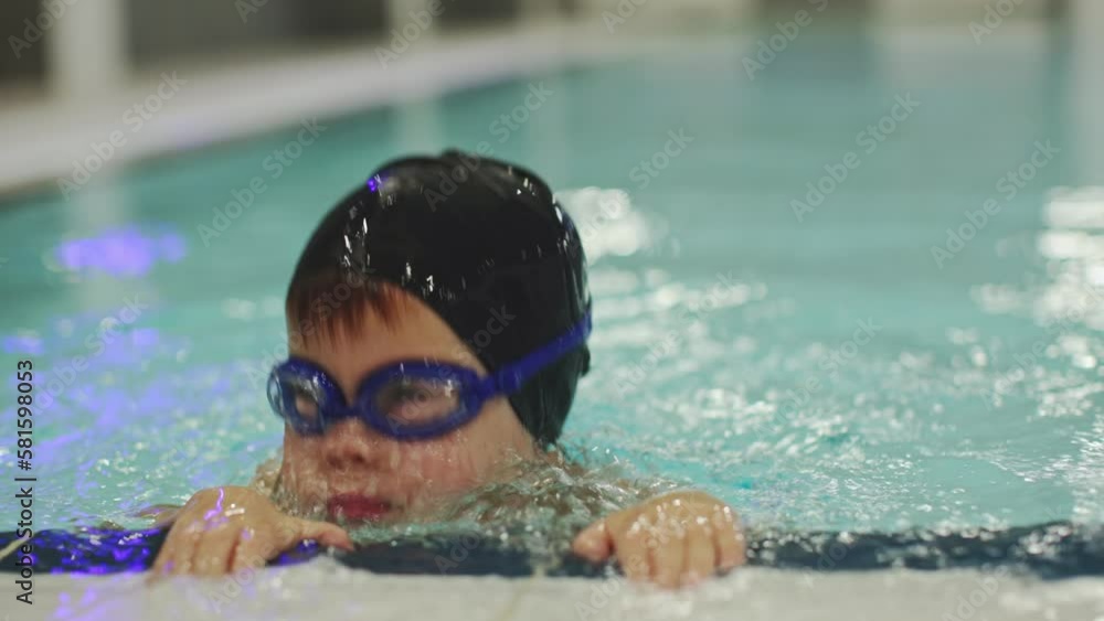 Video Stock little preschooler boy in pool training child learning to