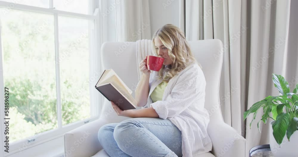 Portrait of happy caucasian plus size woman reading book and drinking coffee in slow motion Portrait of happy caucasian plus size woman reading book and drinking coffee in slow motion