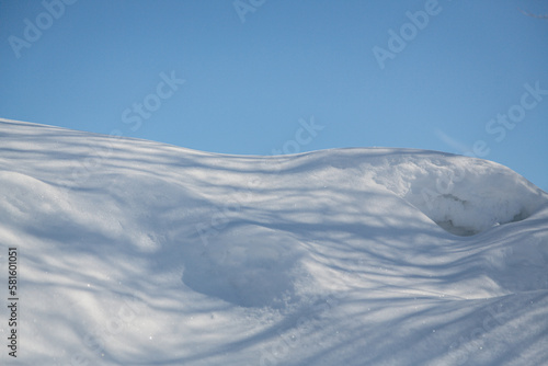 Shadows Across a Snow Bank with Blue Sky in Background, United States