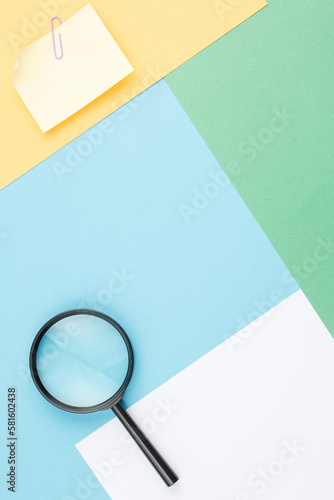 Colored background with magnifying glass