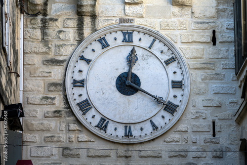Big clock on a stone wall