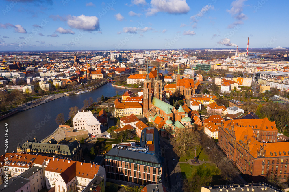 Aerial view of historical part of Wroclaw city - Ostrow Tumski on Oder river overlooking Gothic spires of medieval Cathedral and Collegiate Church in spring, Poland