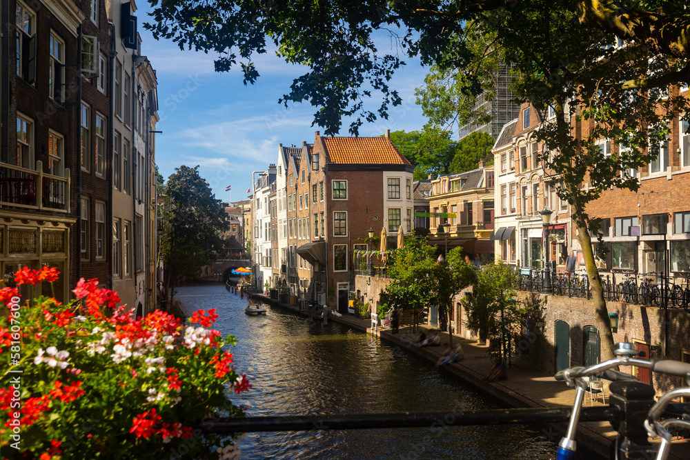 Cityscape of Utrecht, view of city canal embankment with typical butch houses along waterway.
