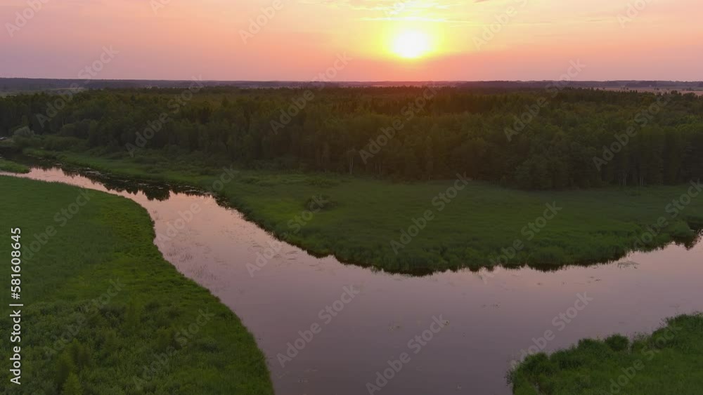 Amazing aerial shot of the Vohandu river in Estonia. Beautiful sunset in the background. Awesome Estonian landscape and nature. Drone slowly moving backwards. Geology shot. Amazing aerial shot of the Vohandu river in Estonia. Beautiful sunset in the background. Awesome Estonian landscape and nature. Drone slowly moving backwards. Geology shot.
