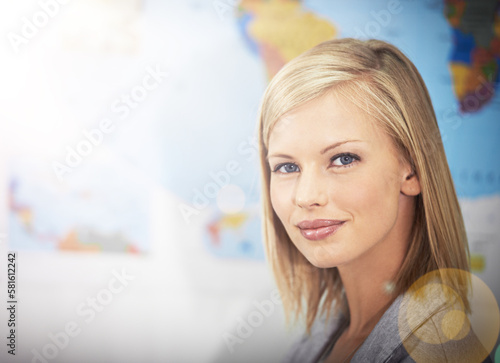 Ill travel the world. Cropped portrait of a young female travel agent working in her office.