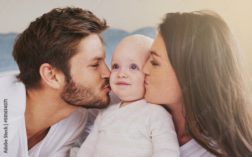 Kisses for their baby. a young couple and their baby daughter in the bedroom. Kisses for their baby. a young couple and their baby daughter in the bedroom.