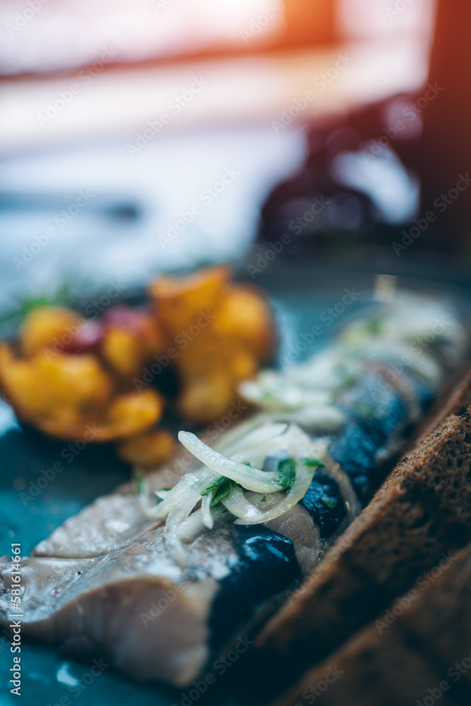fresh marinated herring fish with potato and brown bread and onion in restaurant fresh marinated herring fish with potato and brown bread and onion in restaurant