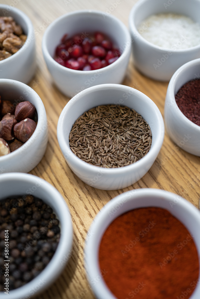 set of spices on wooden background, caraway cumin, hazelnut, pine nut set of spices on wooden background, caraway cumin, hazelnut, pine nut
