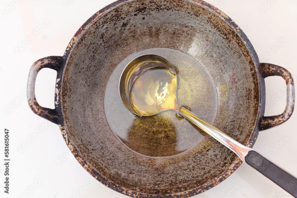 used cooking oil on frying pan. household waste concept