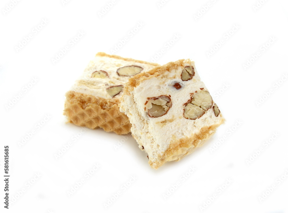 French soft nougat with strawberry flawour and almonds isolated on white background. Greek manolato. White nougat bar isolated. French soft nougat with strawberry flawour and almonds isolated on white background. Greek manolato. White nougat bar isolated.