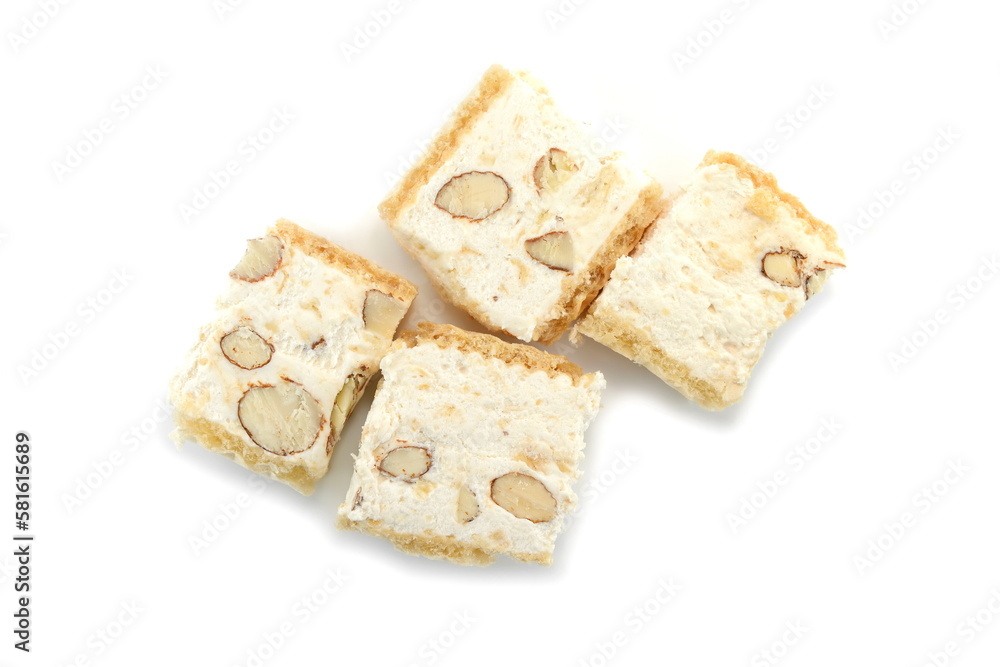 French soft nougat with strawberry flawour and almonds isolated on white background. Greek manolato. White nougat bar isolated. French soft nougat with strawberry flawour and almonds isolated on white background. Greek manolato. White nougat bar isolated.