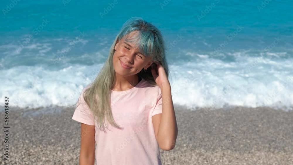 Playful teen by shore landscape. A stylish girl stay on the pebbles exotic shore by the sea and catch the sun rays in summer. Playful teen by shore landscape. A stylish girl stay on the pebbles exotic shore by the sea and catch the sun rays in summer.