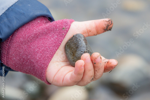 child holding stones