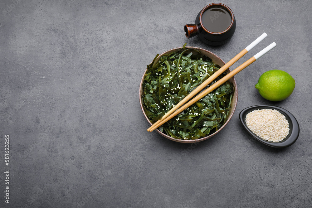Fresh laminaria (kelp) seaweed served on gray table, flat lay. Space for text Fresh laminaria (kelp) seaweed served on gray table, flat lay. Space for text