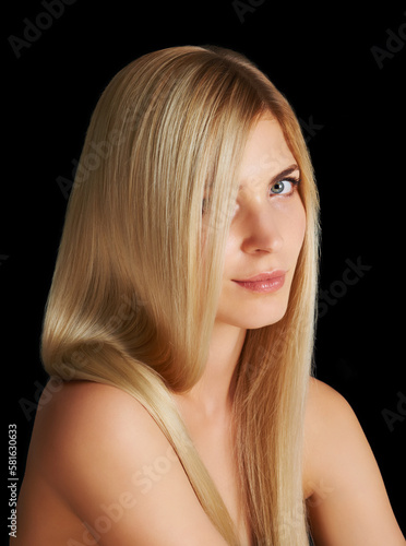 All natural blonde locks. Portrait of an attractive blonde woman isolated on black.