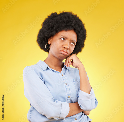 Photos Black woman, sad face and thinking in studio upset, sulking and disappointed on a yellow background