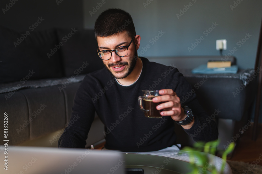 A young guy is using his laptop to study or do business from home
A young guy is using his laptop to study or do business from home