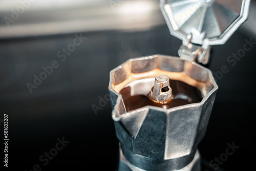 close up of a stove with hot coffee inside