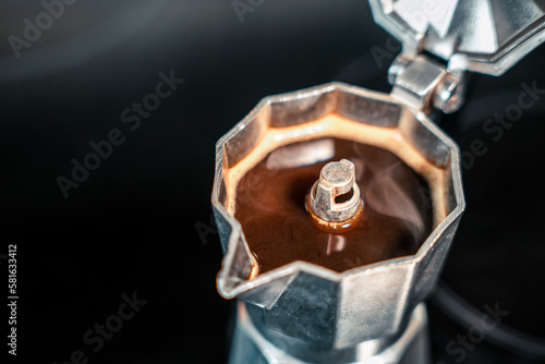 close up of a stove with hot coffee inside