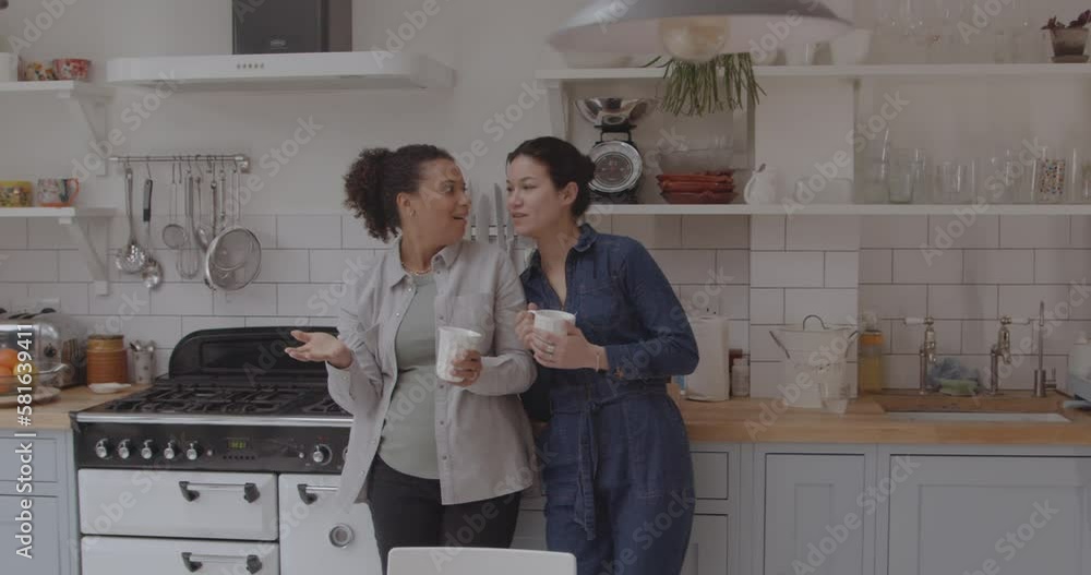 Lesbian Couple at Home in Kitchen Planning Home Decoration Lesbian Couple at Home in Kitchen Planning Home Decoration